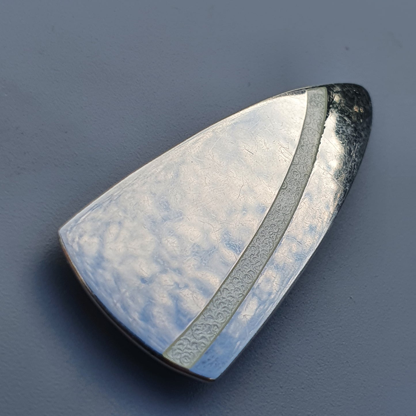 Triangular textured metal white enamel brooch with dark stripe by Platinoro