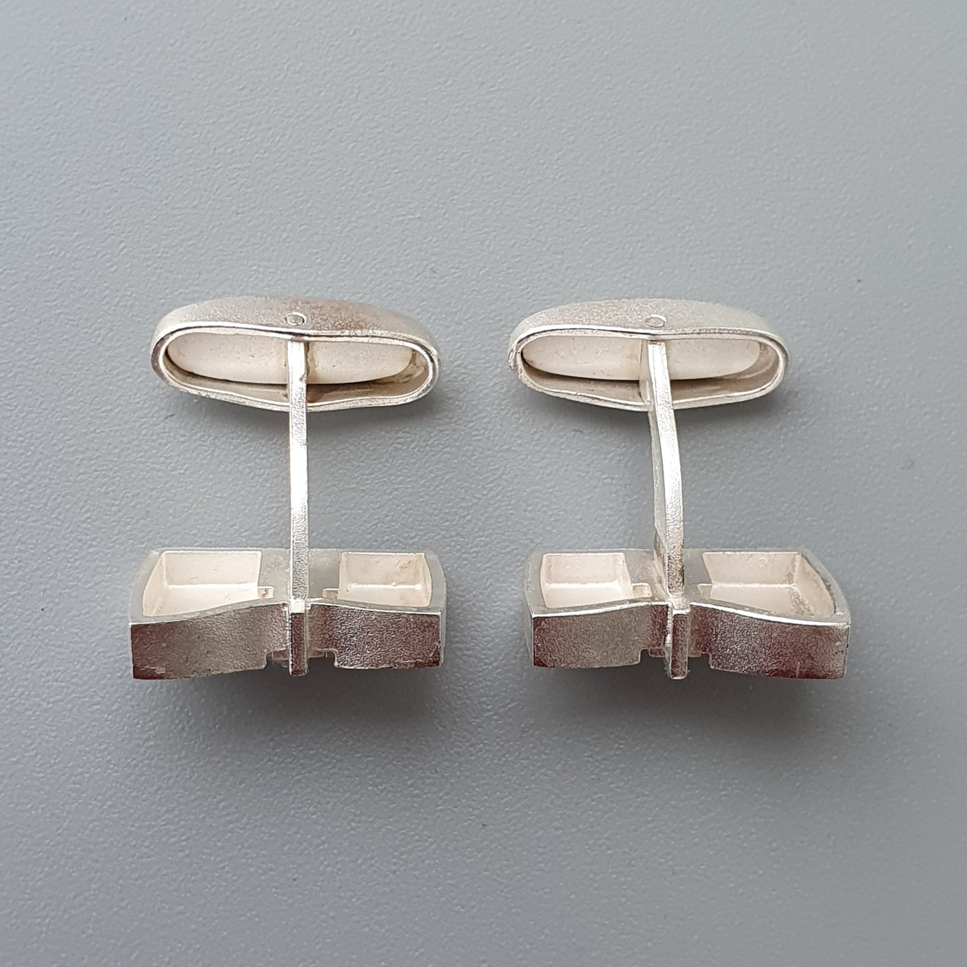 Pair of modernist silver cufflinks with geometric cube-like designs.