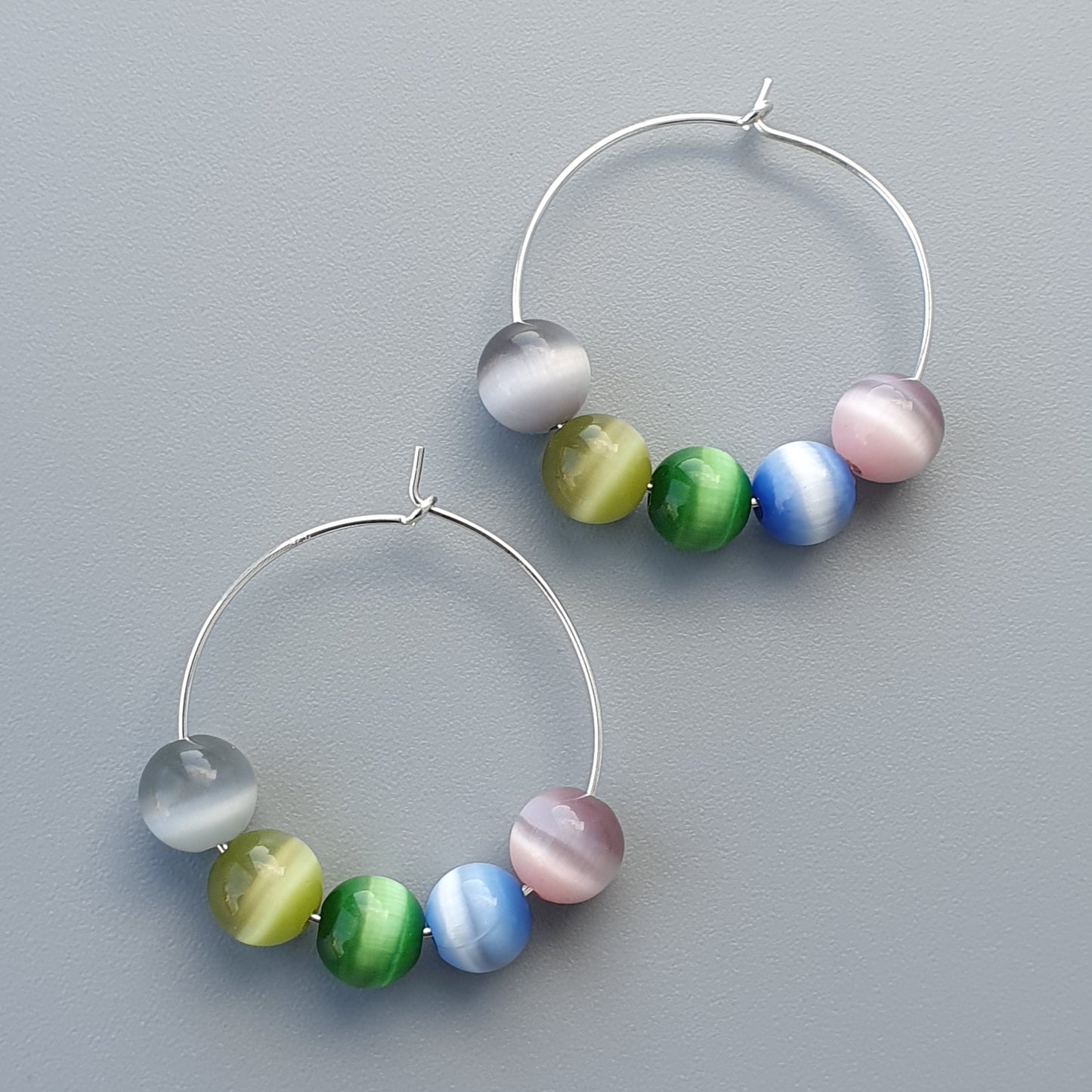 Pair of hoop earrings with colorful glass beads.