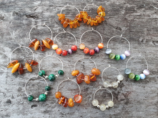 Collection of handmade hoop earrings featuring colorful beads and autumn leaves.