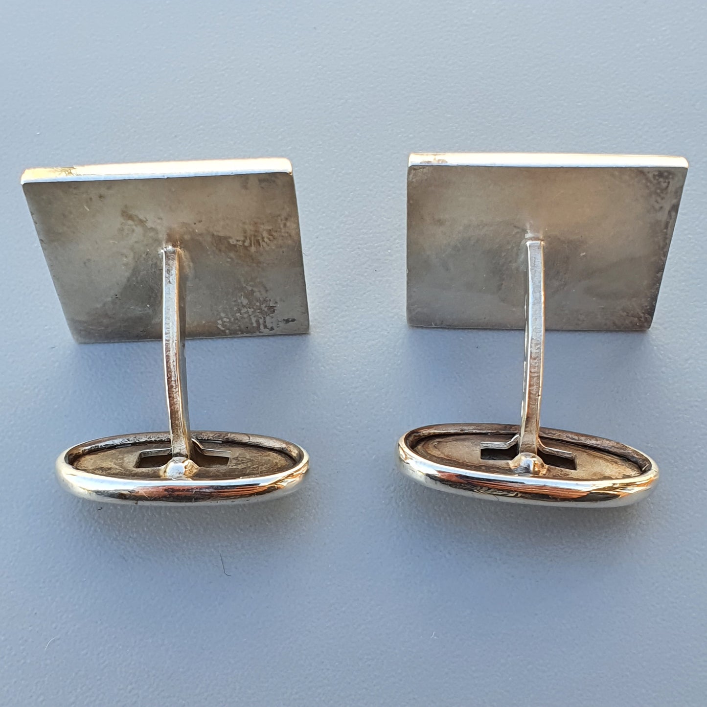 Pair of silver-toned metal cufflinks with square faces.