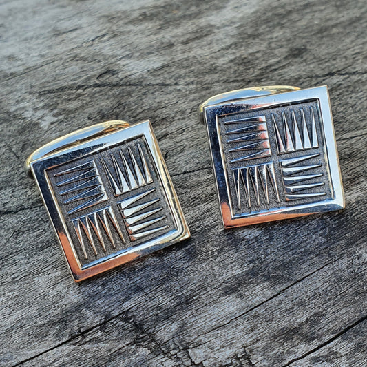 Pair of square silver cufflinks with geometric line patterns.