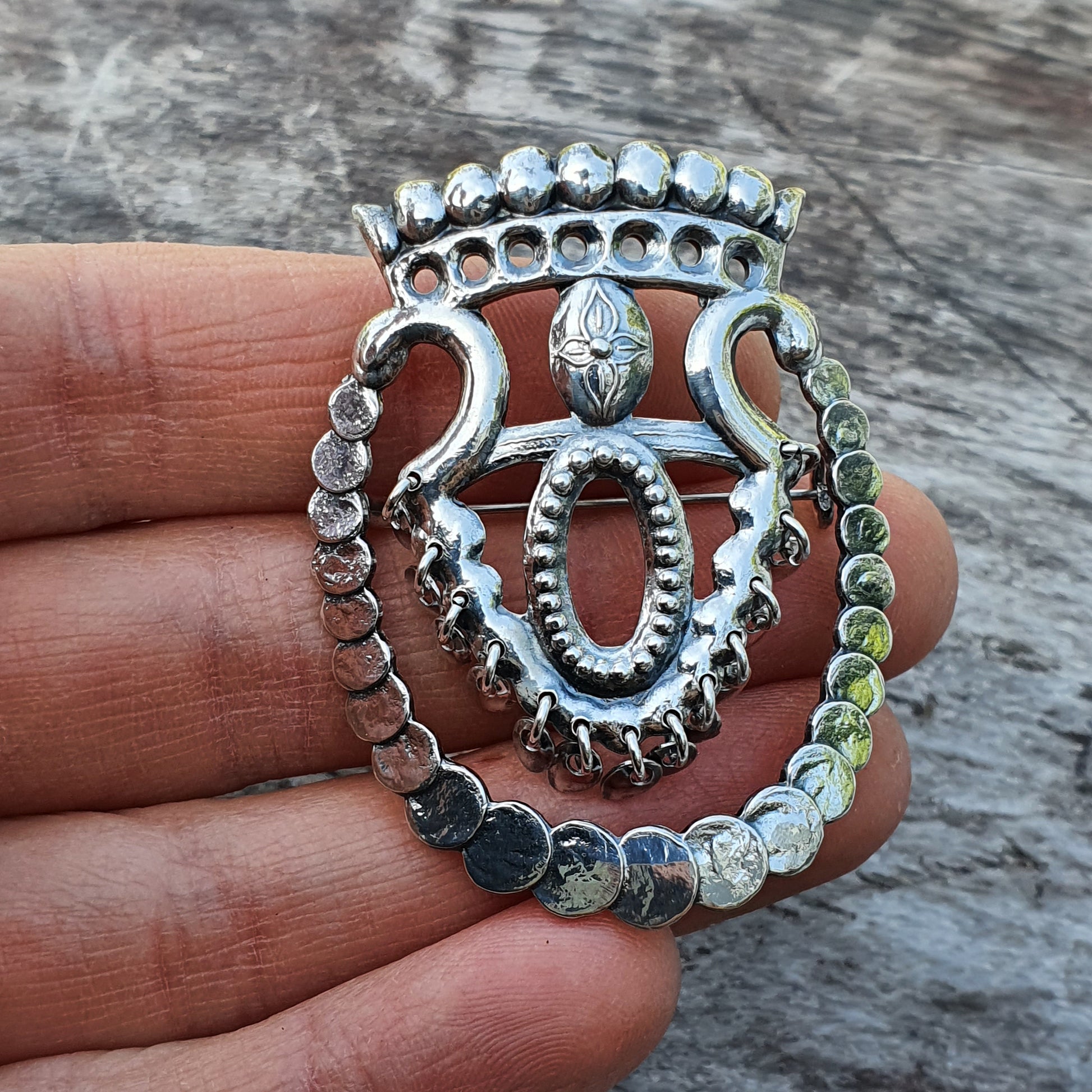 Ornate silver ring with a crown-like design featuring intricate metalwork and beaded details.