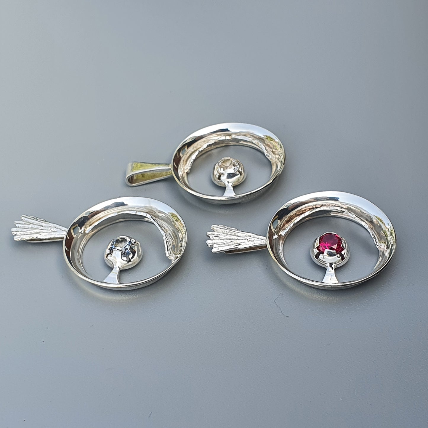 Three oval-shaped silver serving dishes or trays with decorative mushroom-like elements in the center.