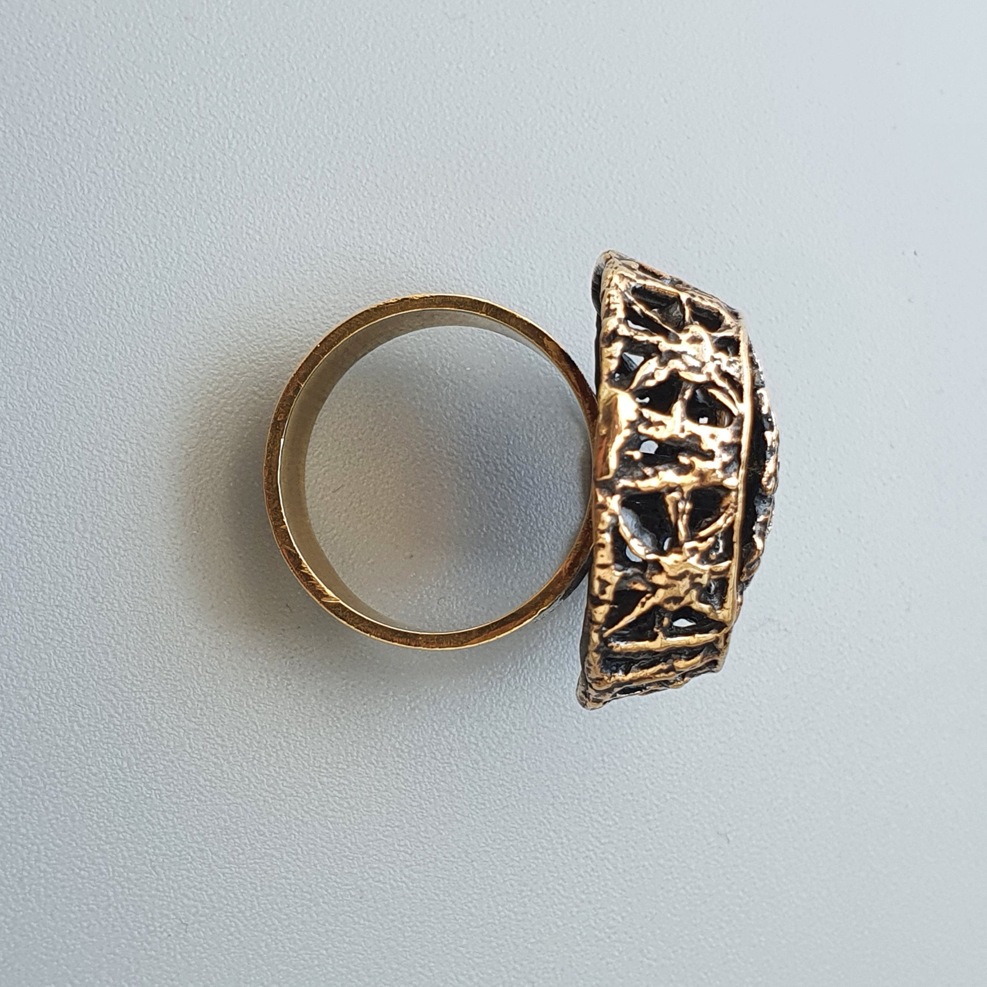 Ornate gold ring with an intricate, dome-shaped filigree top.