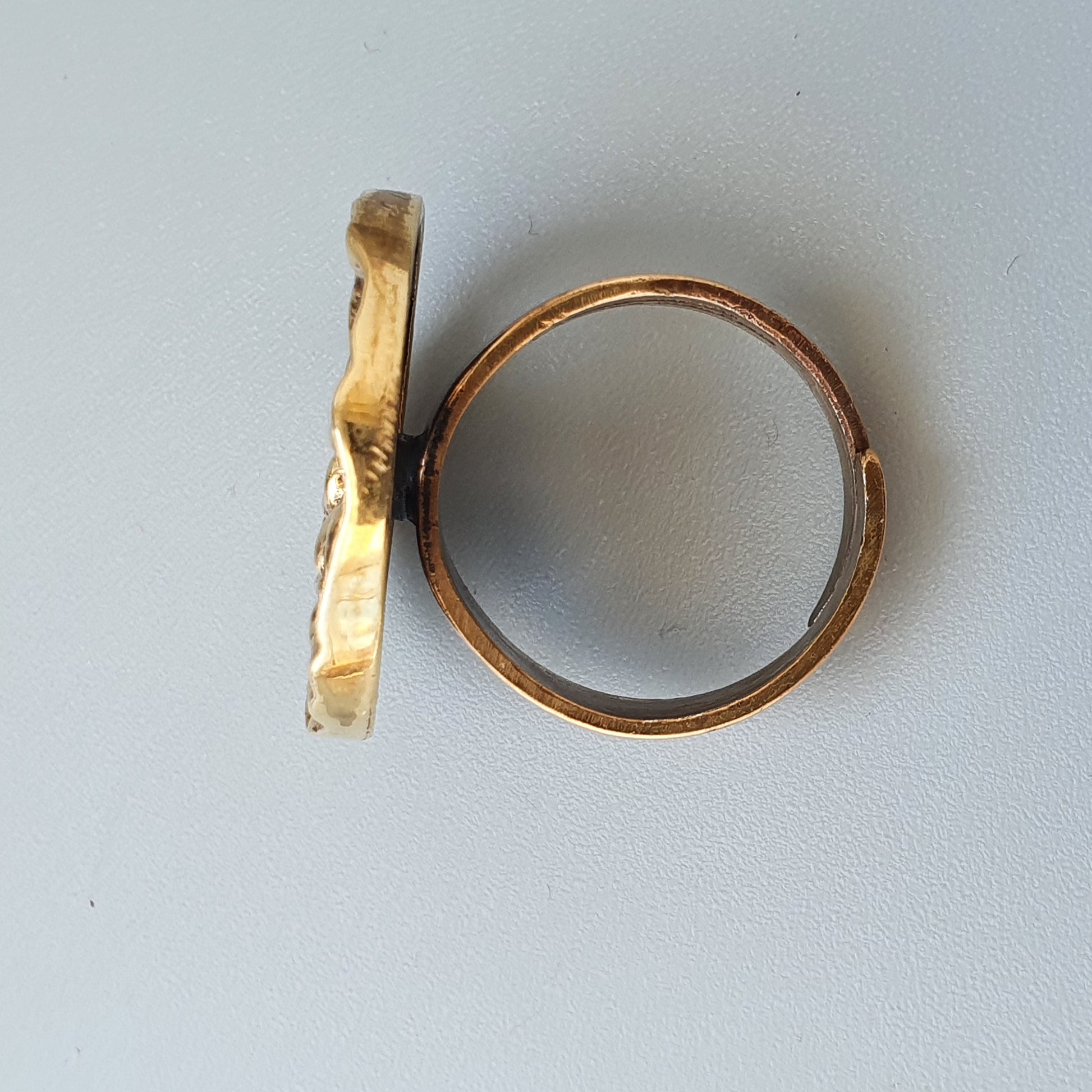 Two gold rings, one plain band and one with a textured or hammered surface.