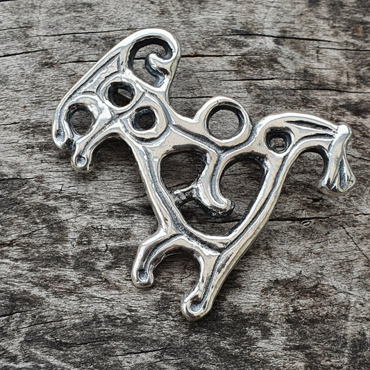 Silver-colored metal pendant or charm shaped like a stylized horse.