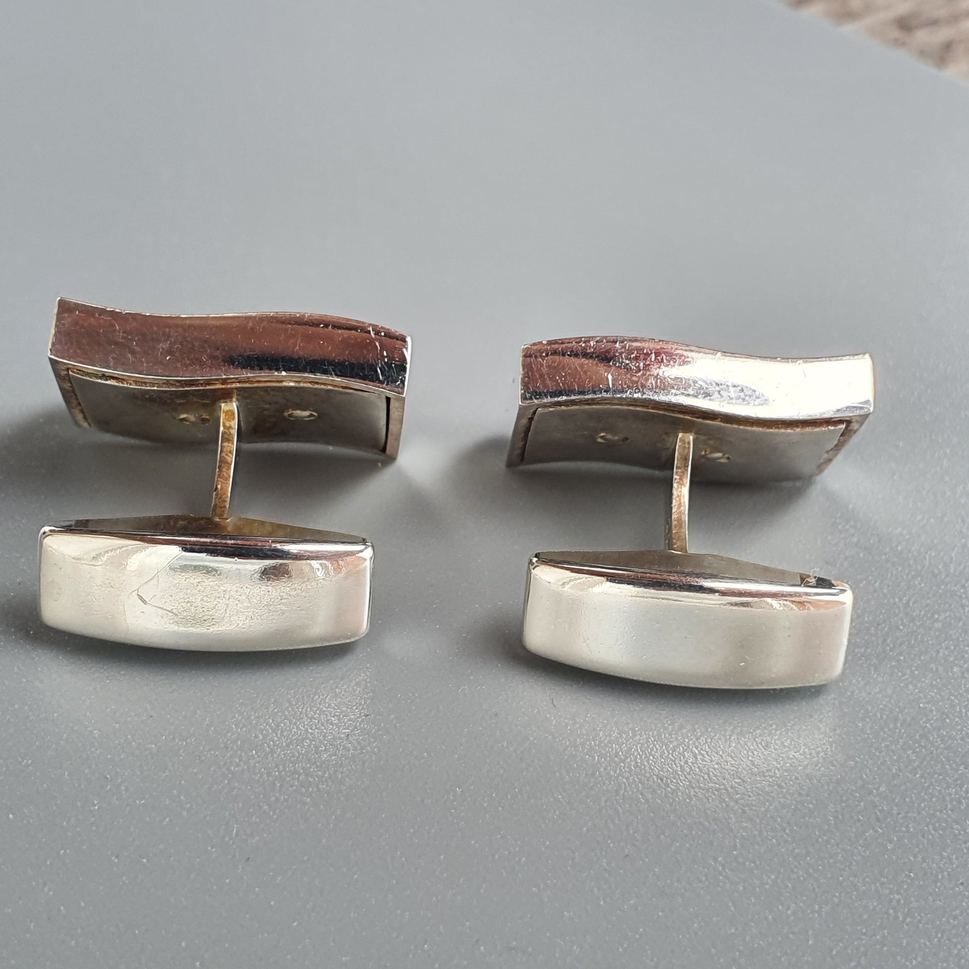 Pair of vintage cufflinks with rectangular silver and brown enamel designs.