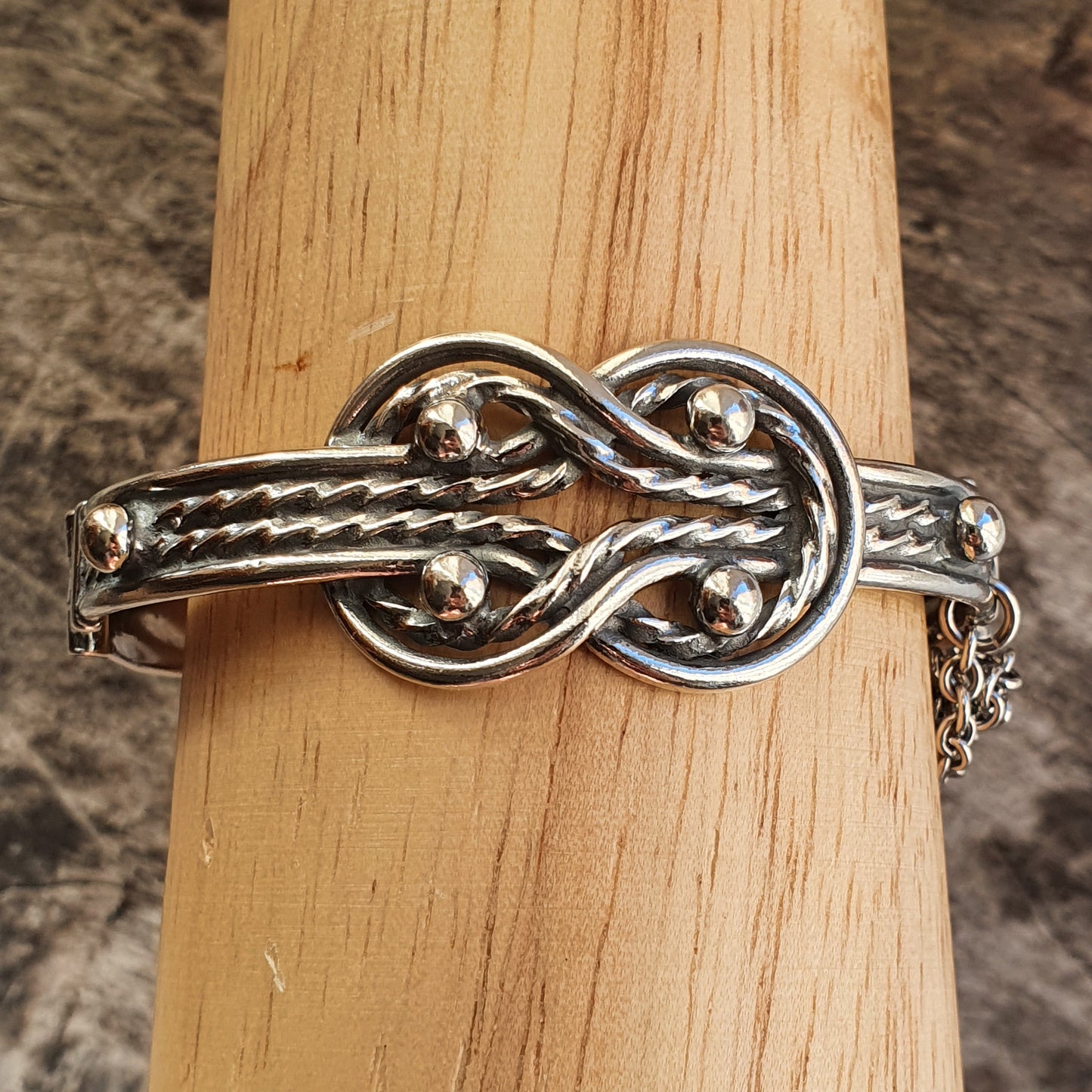 Silver bracelet featuring an intricate knot design.