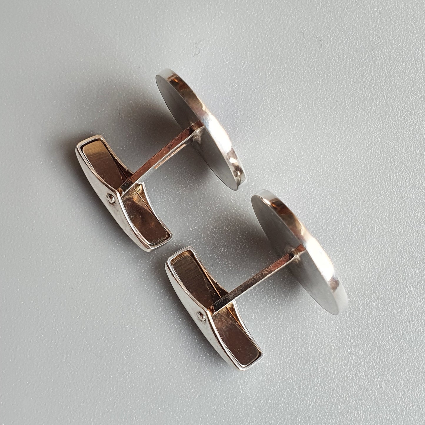 Pair of silver-colored metal cufflinks with rectangular faces.