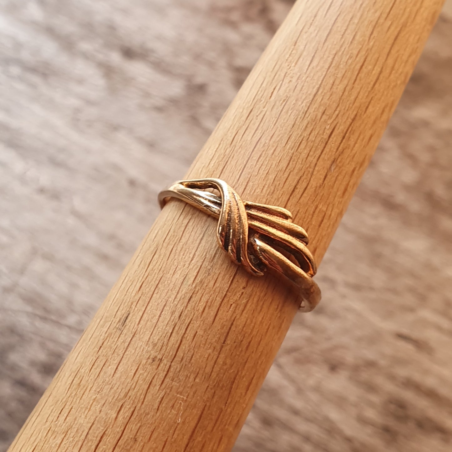 Gold ring with an intertwined knot design.