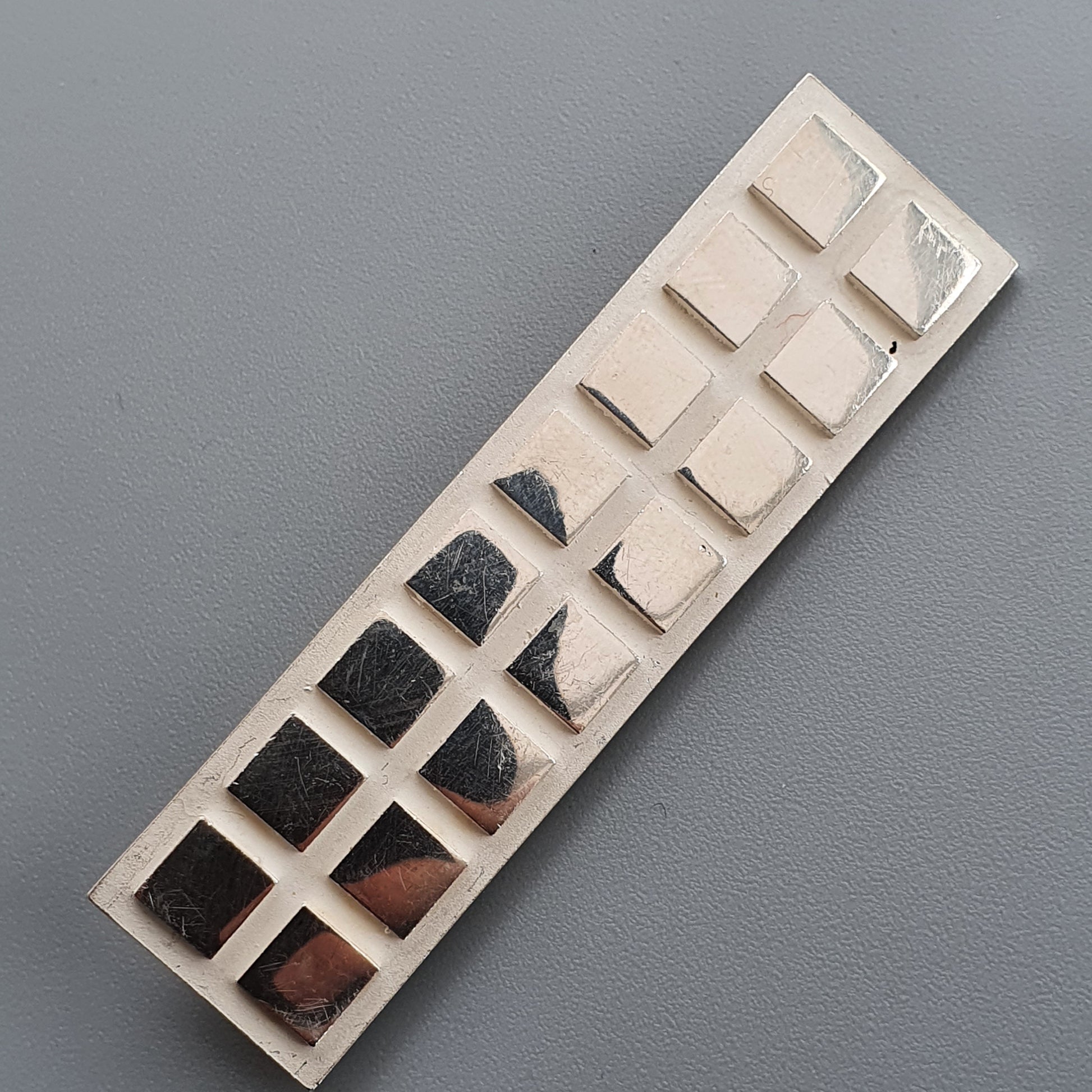 Rectangular ceramic mold with indentations for Finnish Minimalist Silver Brooch design