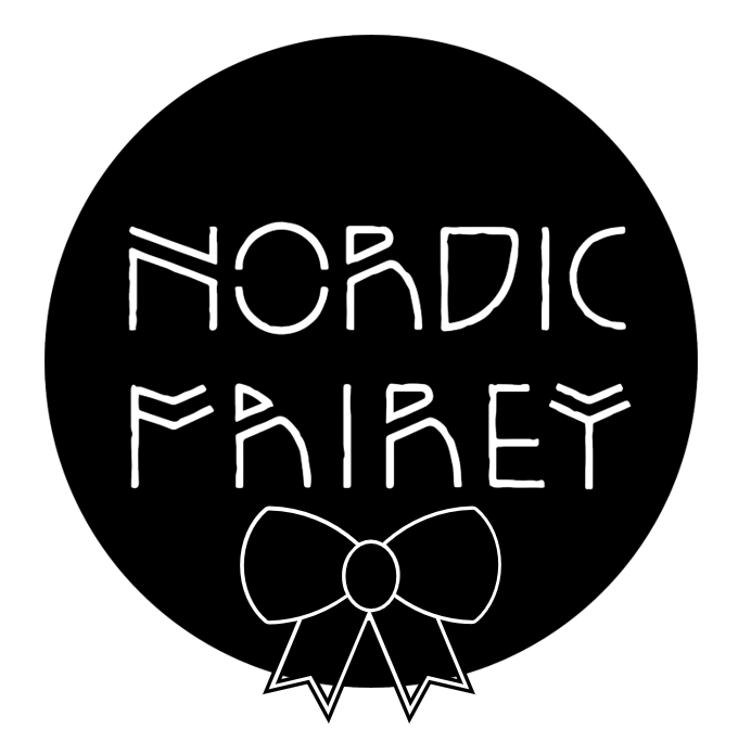 Circular black logo with white text reading ’NORDIC FAIREY’ and a bow design underneath.